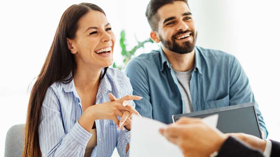 website couple sitting at desk